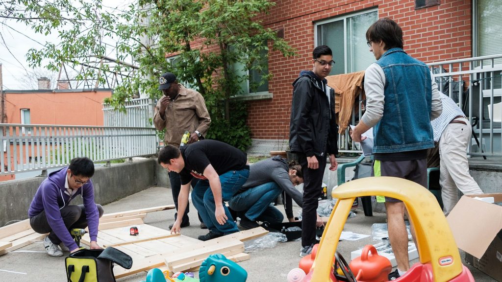 The inFlow team works to assemble a picnic bench in the backyard