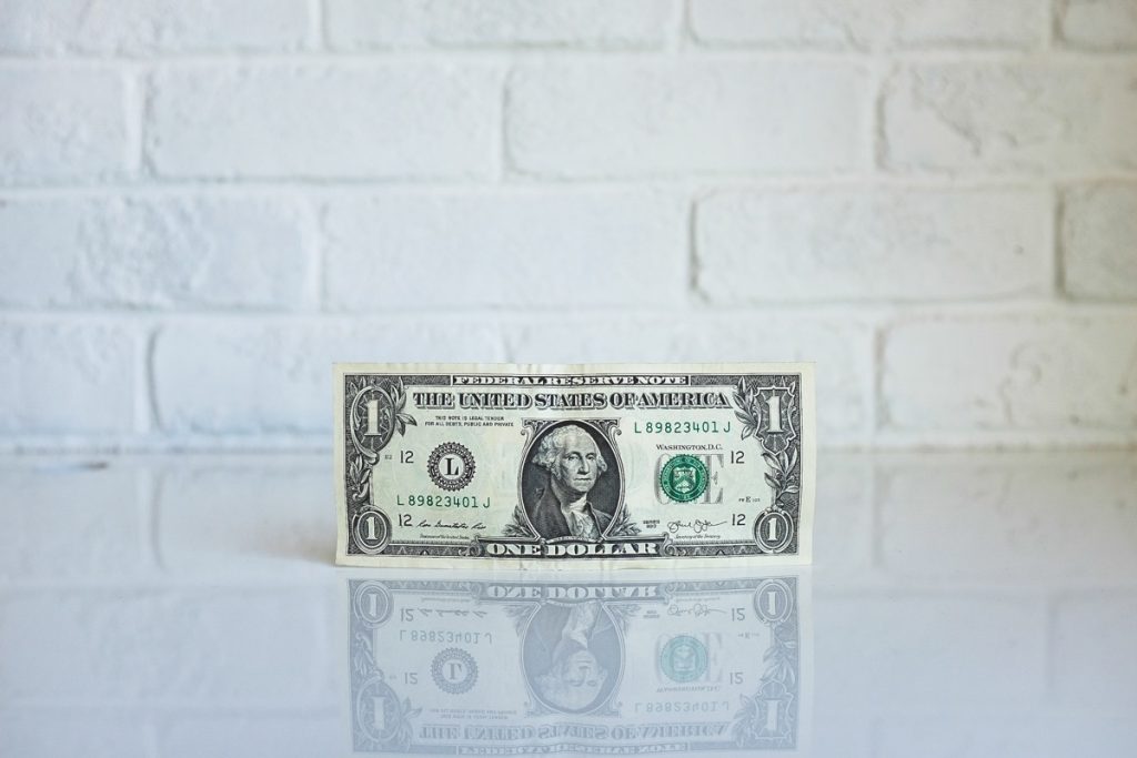 Photo of a US dollar bill (credit to neonbrand from Unsplash)